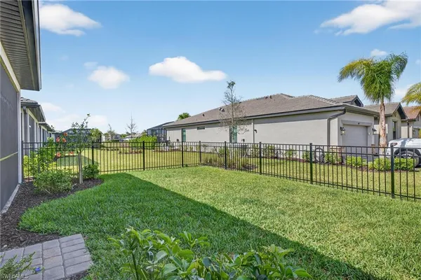 a view of a house with a big yard and potted plants