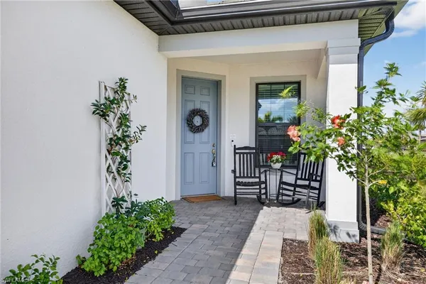 a entryway to the house with potted plants