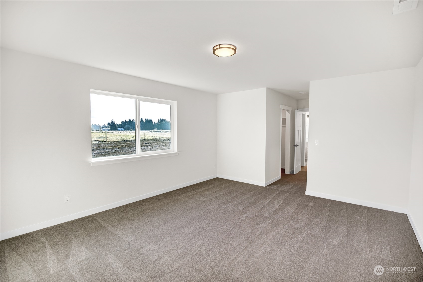 7507 182nd Trail Southwest Rochester, WA 98579 - Photo 7 of 22 an empty room with windows