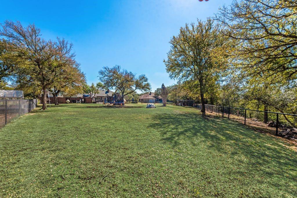 83 Crown Road Willow Park, TX 76087 - Photo 29 of 35 Expansive lawn featuring mature trees and perimeter fencing