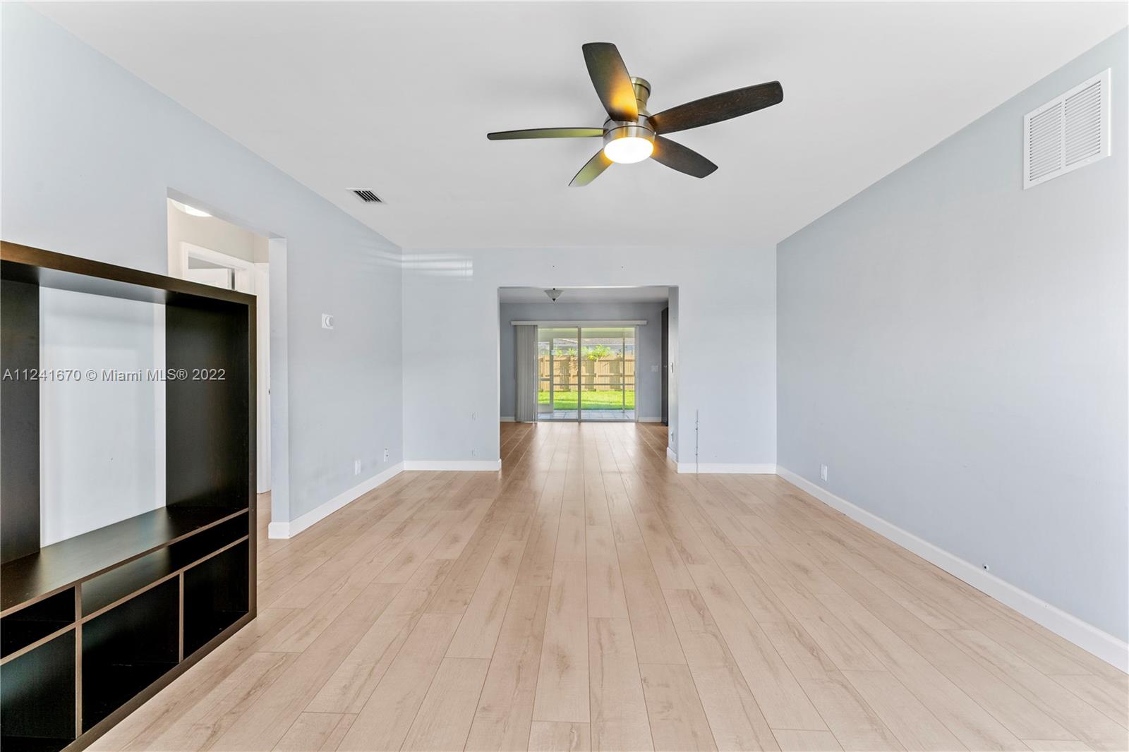 3166 Northwest 68th Court Fort Lauderdale, FL 33309 - Photo 11 of 36 a view of empty room with wooden floor and fan