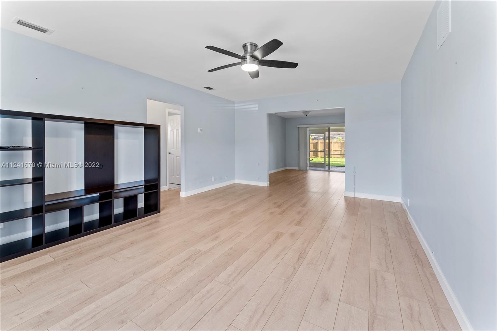 3166 Northwest 68th Court Fort Lauderdale, FL 33309 - Photo 12 of 36 a view of empty room with wooden floor and fan