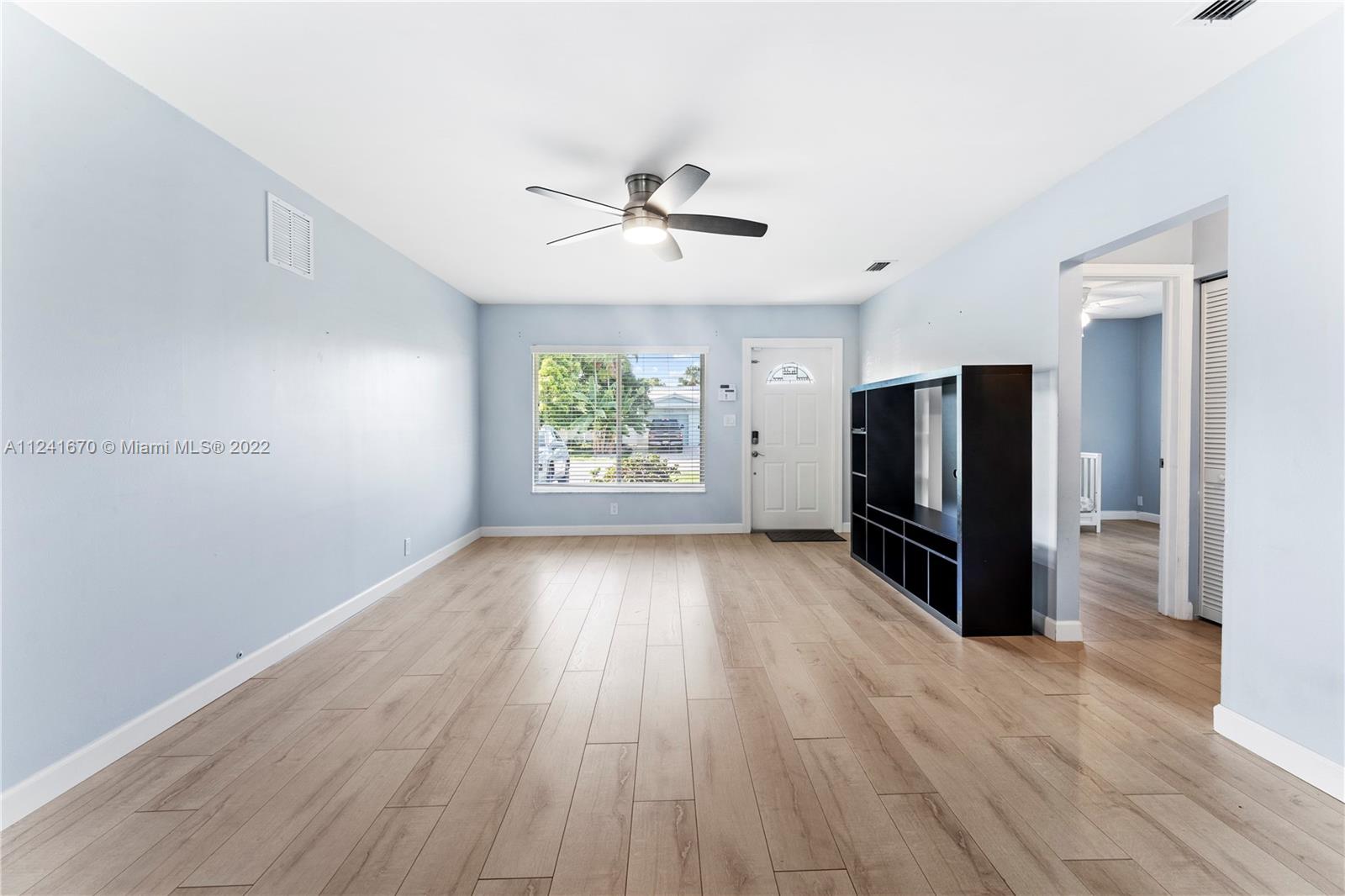 3166 Northwest 68th Court Fort Lauderdale, FL 33309 - Photo 13 of 36 wooden floor in an empty room with a window