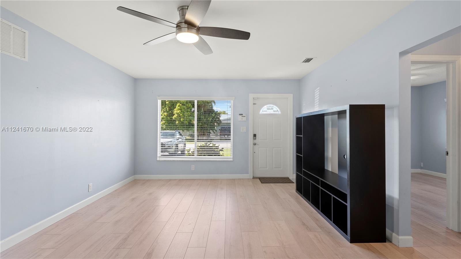 3166 Northwest 68th Court Fort Lauderdale, FL 33309 - Photo 15 of 36 wooden floor in an empty room with a window