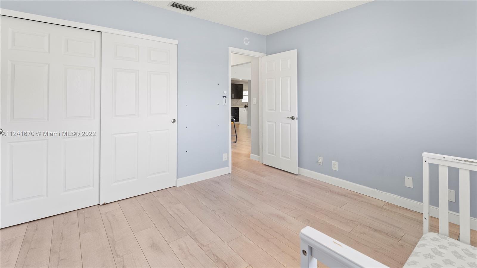 3166 Northwest 68th Court Fort Lauderdale, FL 33309 - Photo 16 of 36 a view of an empty room with wooden floor