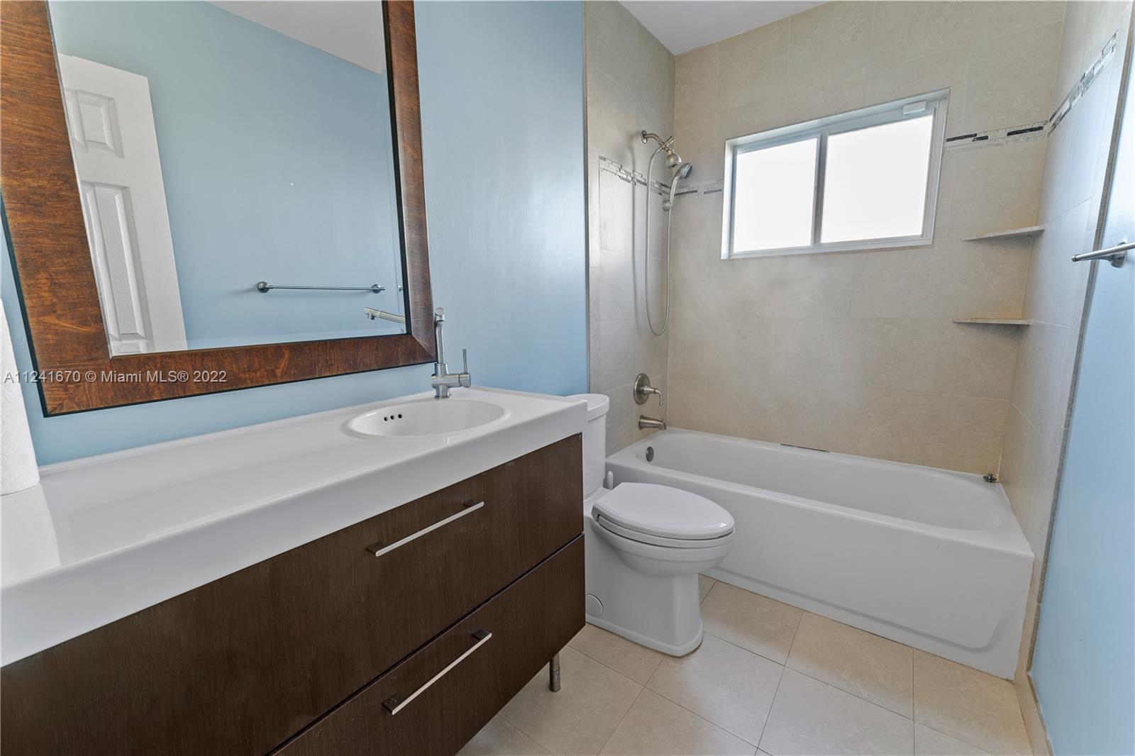 3166 Northwest 68th Court Fort Lauderdale, FL 33309 - Photo 20 of 36 a bathroom with a sink a toilet and shower