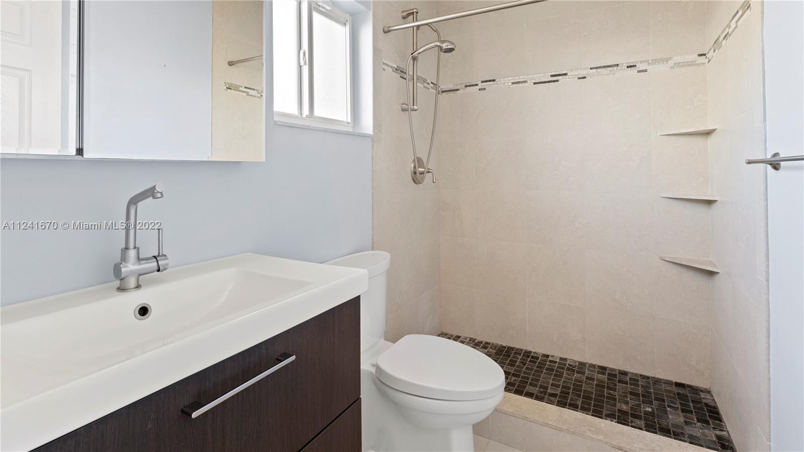 3166 Northwest 68th Court Fort Lauderdale, FL 33309 - Photo 22 of 36 a bathroom with a sink a toilet and shower
