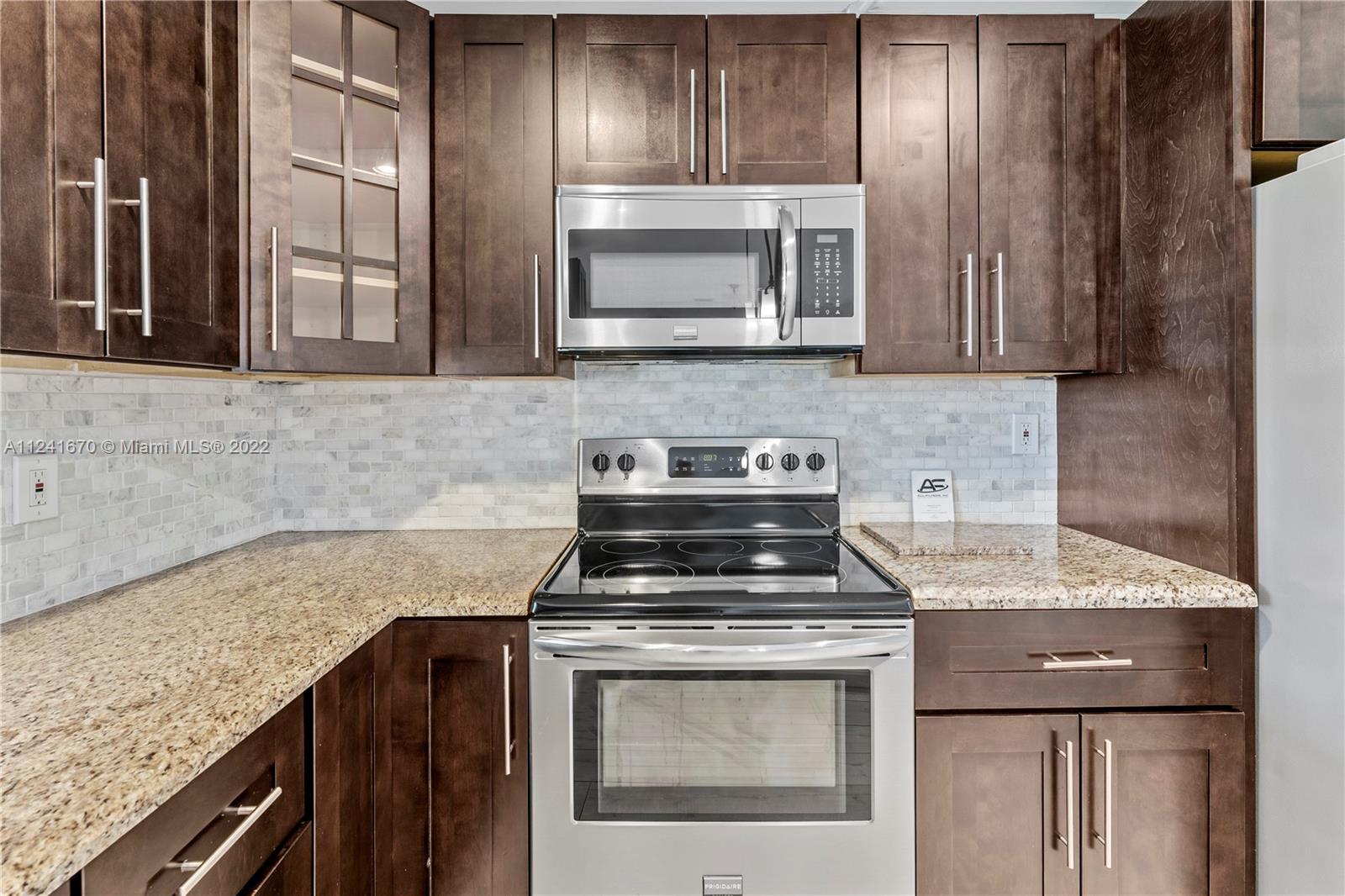 3166 Northwest 68th Court Fort Lauderdale, FL 33309 - Photo 28 of 36 a kitchen with a stove microwave and sink