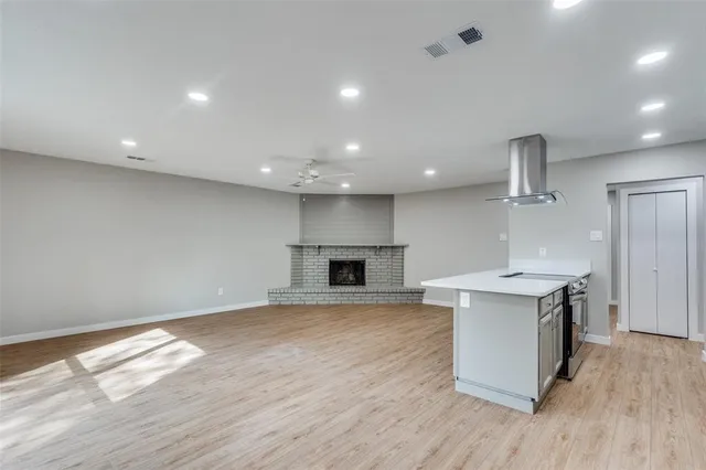 a view of kitchen with a sink wooden floor and a window