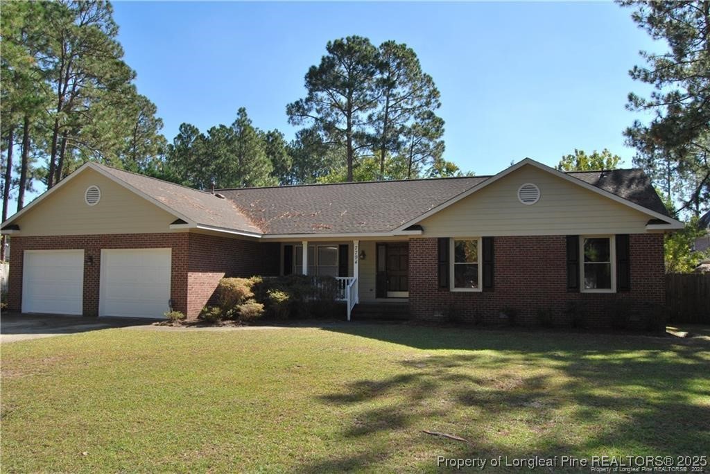 7794 Privet Court Fayetteville, NC 28311 - Photo 1 of 19 a front view of a house with a yard and garage