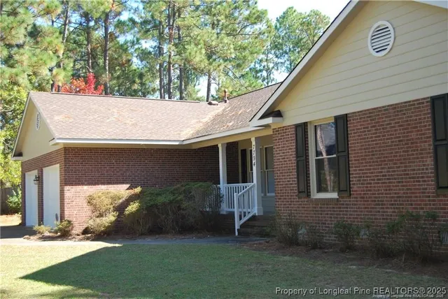 a view of house with a yard