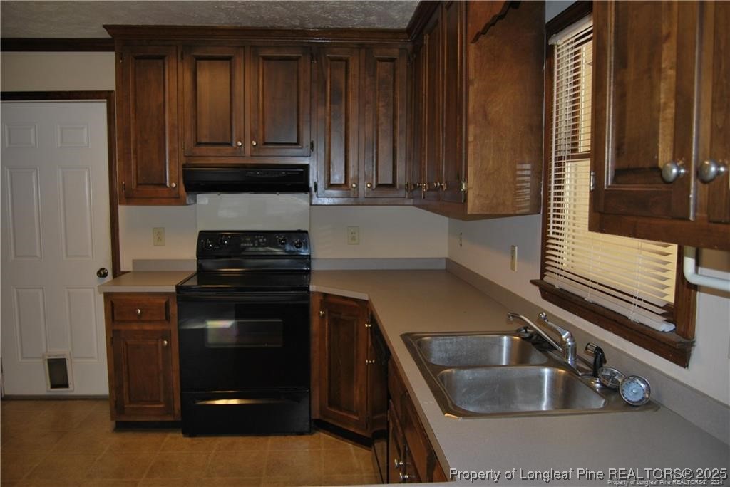 7794 Privet Court Fayetteville, NC 28311 - Photo 6 of 19 a kitchen with granite countertop a sink and a stove top oven