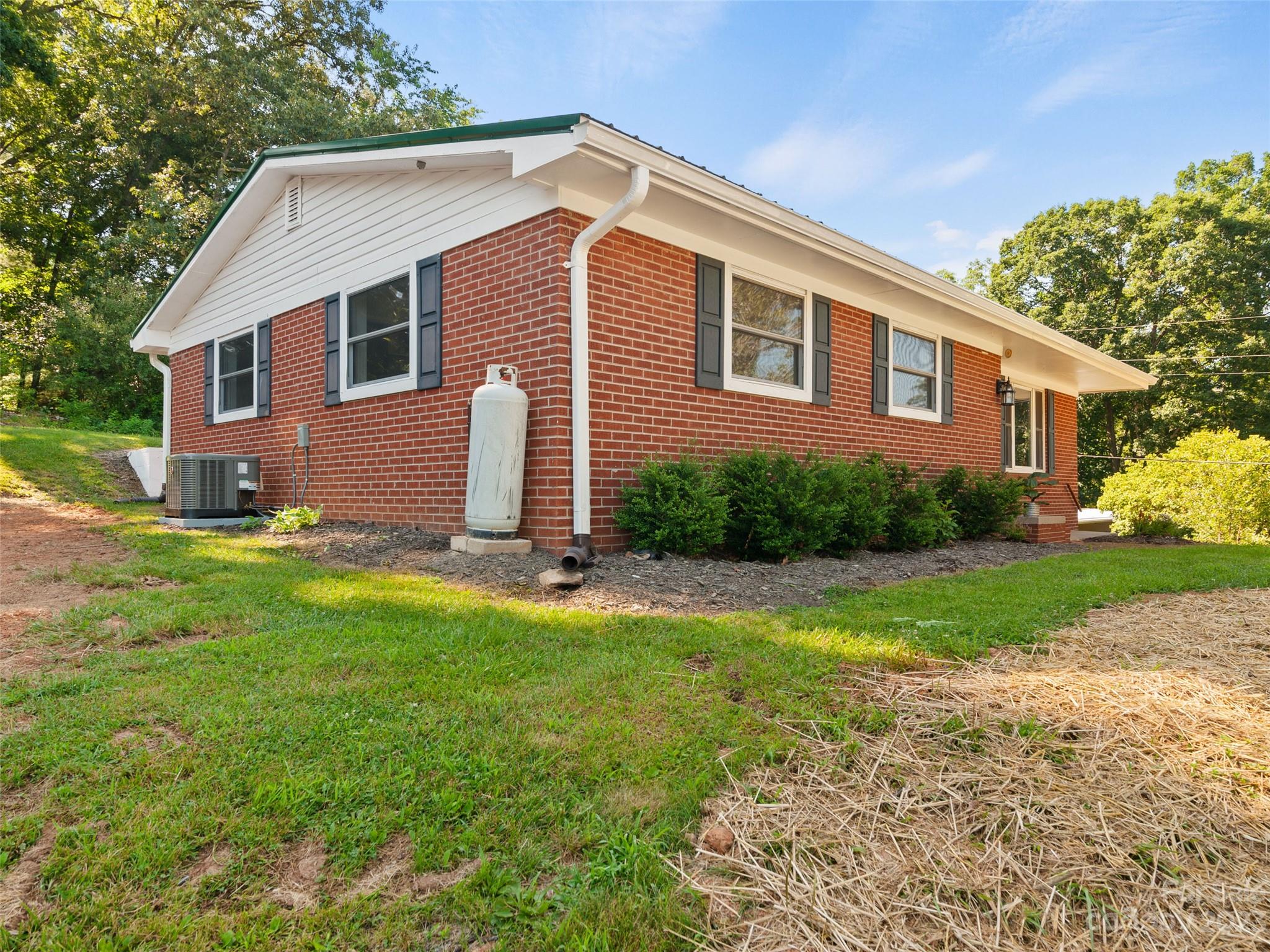 79 Oak Street Clyde, NC 28721 - Photo 2 of 23 a front view of house with yard and green space