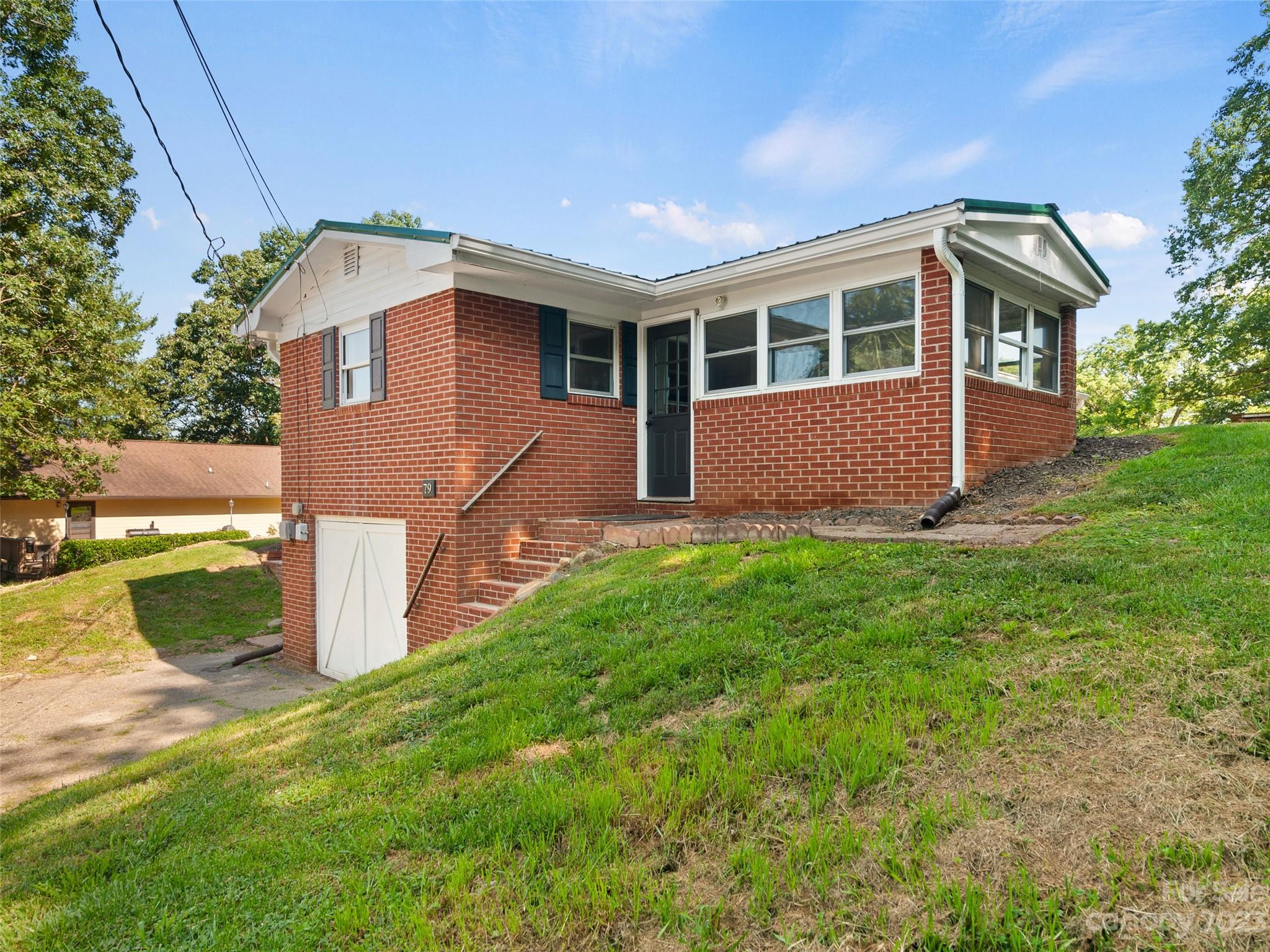 79 Oak Street Clyde, NC 28721 - Photo 22 of 23 a view of front of house with a yard