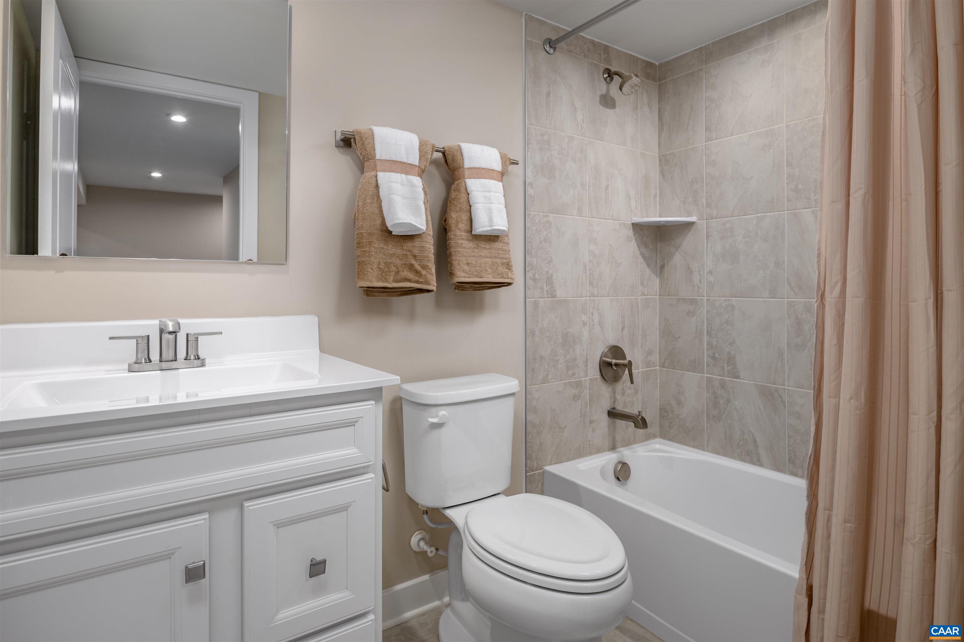 5159 Lazy Branch Lane Keswick, VA 22947 - Photo 15 of 17 a bathroom with a sink a toilet and shower