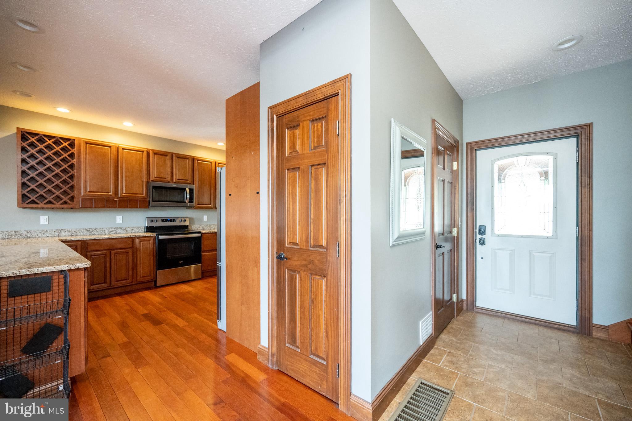 1909 Pysell Crosscut Road Oakland, MD 21550 - Photo 11 of 82 a kitchen with stainless steel appliances granite countertop a refrigerator and a stove top oven