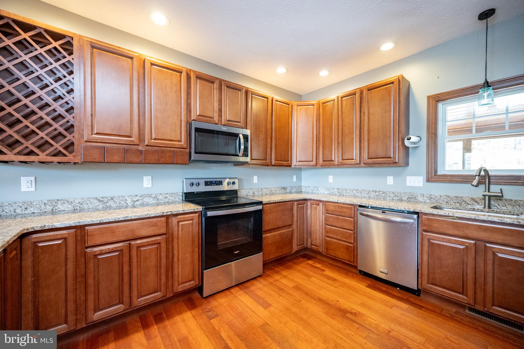 1909 Pysell Crosscut Road Oakland, MD 21550 - Photo 13 of 82 a kitchen with stainless steel appliances granite countertop stove top oven microwave and cabinets