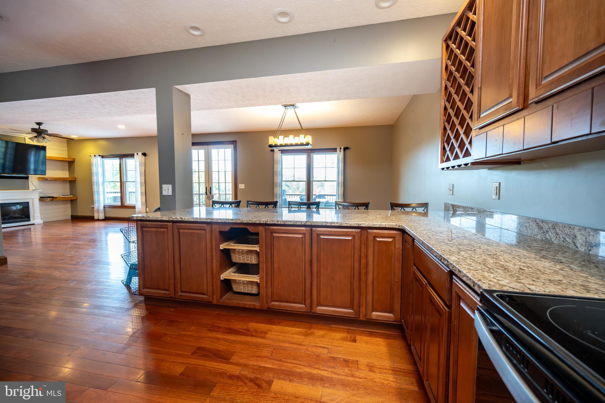 1909 Pysell Crosscut Road Oakland, MD 21550 - Photo 16 of 82 a kitchen with stainless steel appliances granite countertop a sink a stove and a wooden floors
