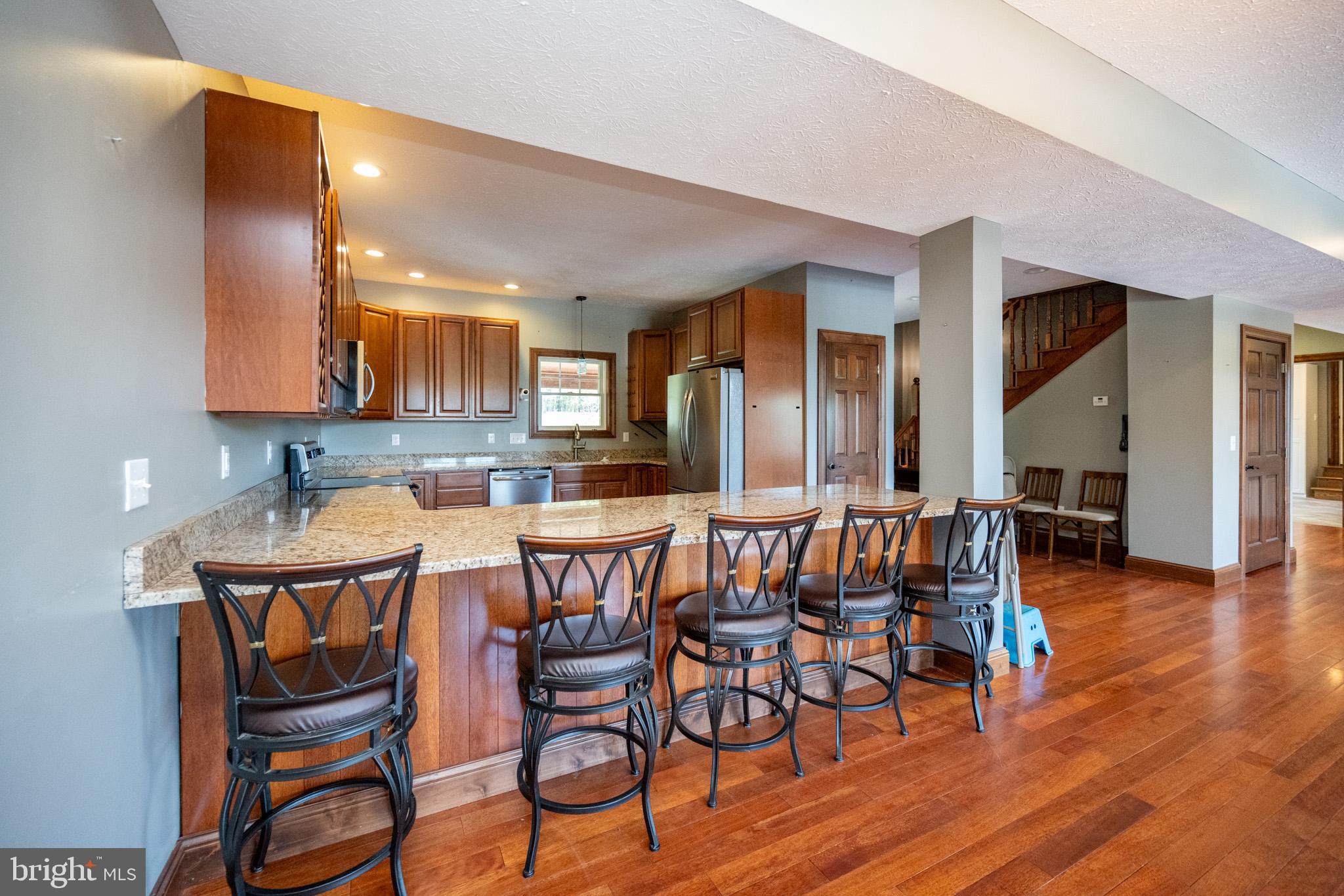1909 Pysell Crosscut Road Oakland, MD 21550 - Photo 18 of 82 a view of a dining room with furniture and wooden floor
