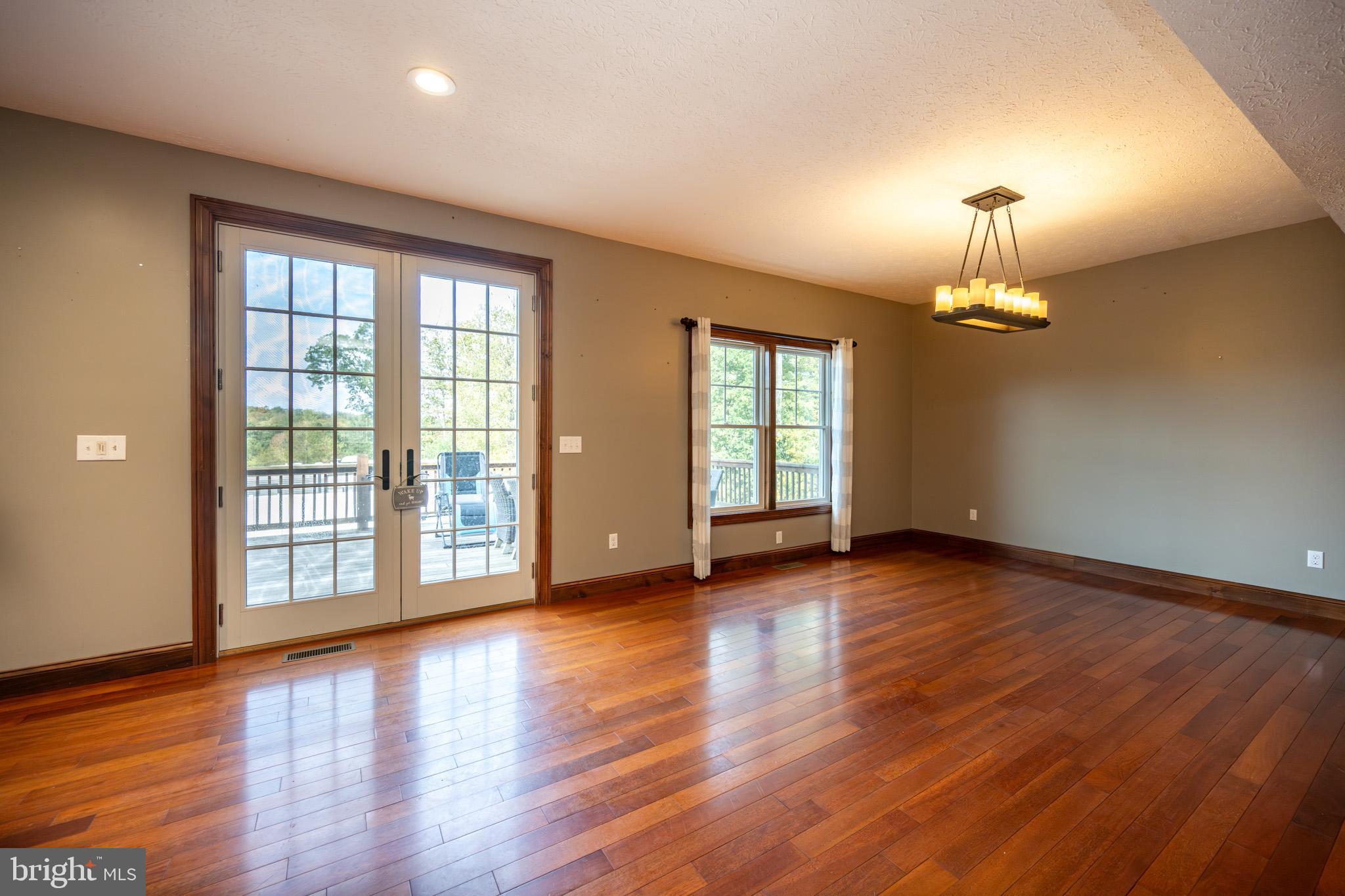 1909 Pysell Crosscut Road Oakland, MD 21550 - Photo 20 of 82 a view of an empty room with wooden floor and a window