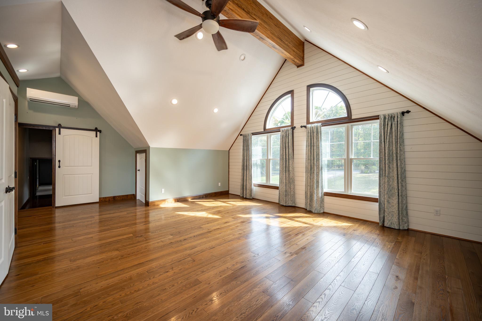 1909 Pysell Crosscut Road Oakland, MD 21550 - Photo 41 of 82 a view of a livingroom with wooden floor a ceiling fan and windows