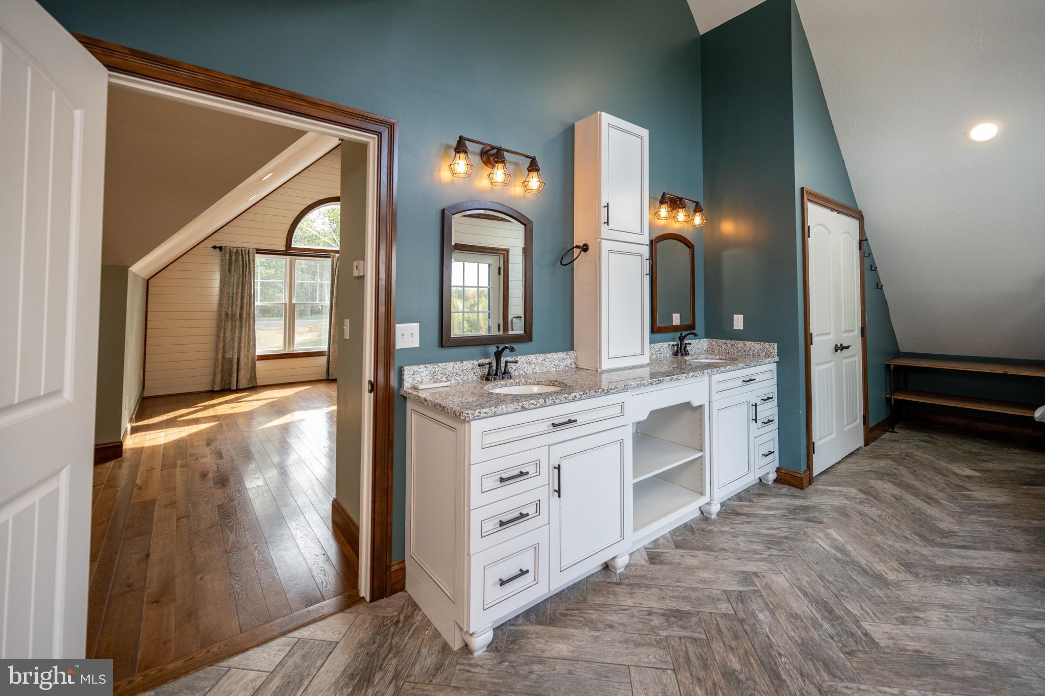 1909 Pysell Crosscut Road Oakland, MD 21550 - Photo 46 of 82 a bathroom with a double vanity sink and a mirror
