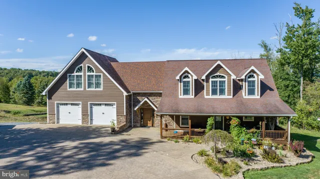 a kitchen with granite countertop stainless steel appliances a refrigerator cabinets and wooden floor