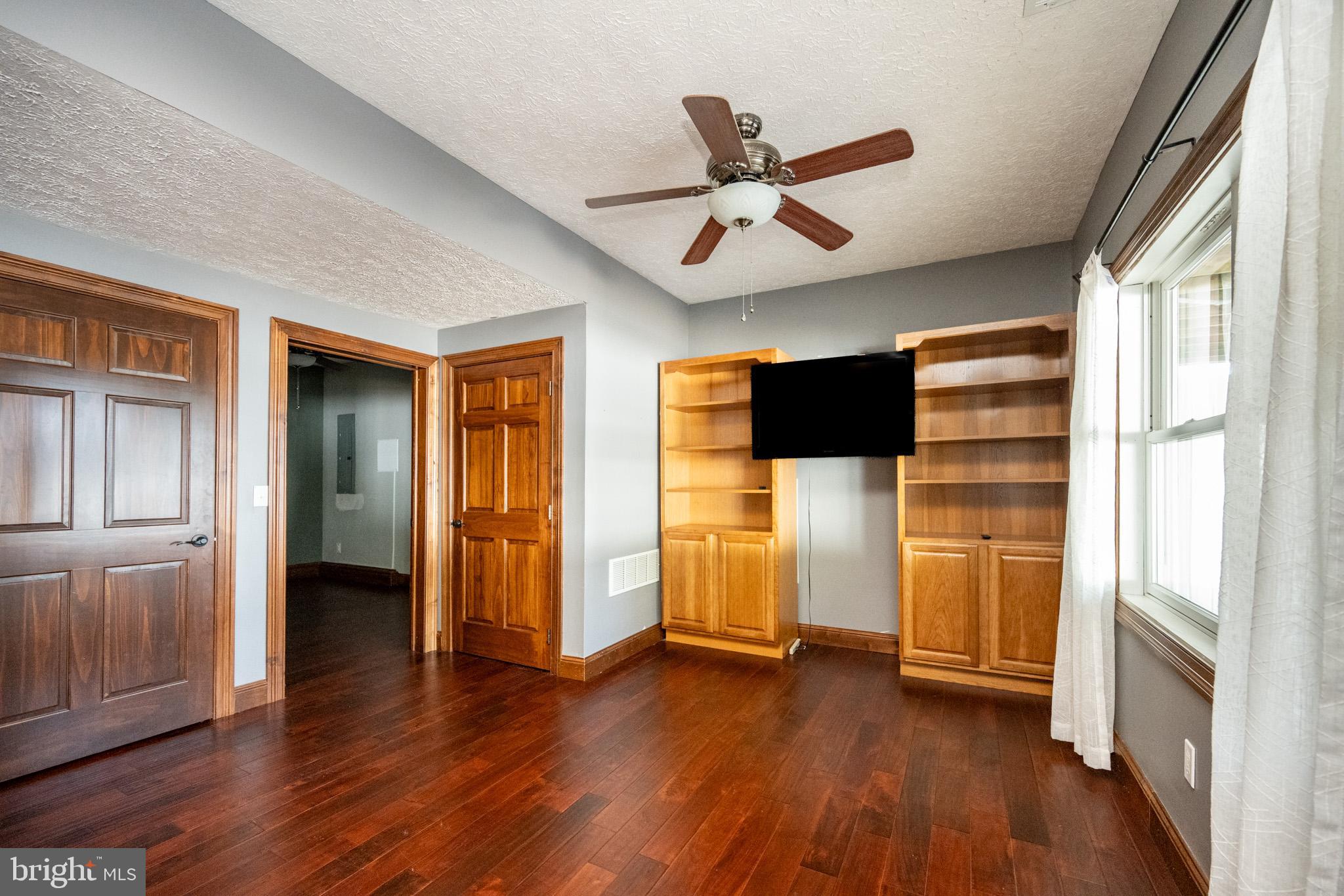 1909 Pysell Crosscut Road Oakland, MD 21550 - Photo 62 of 82 a view of a livingroom with wooden floor and a ceiling fan