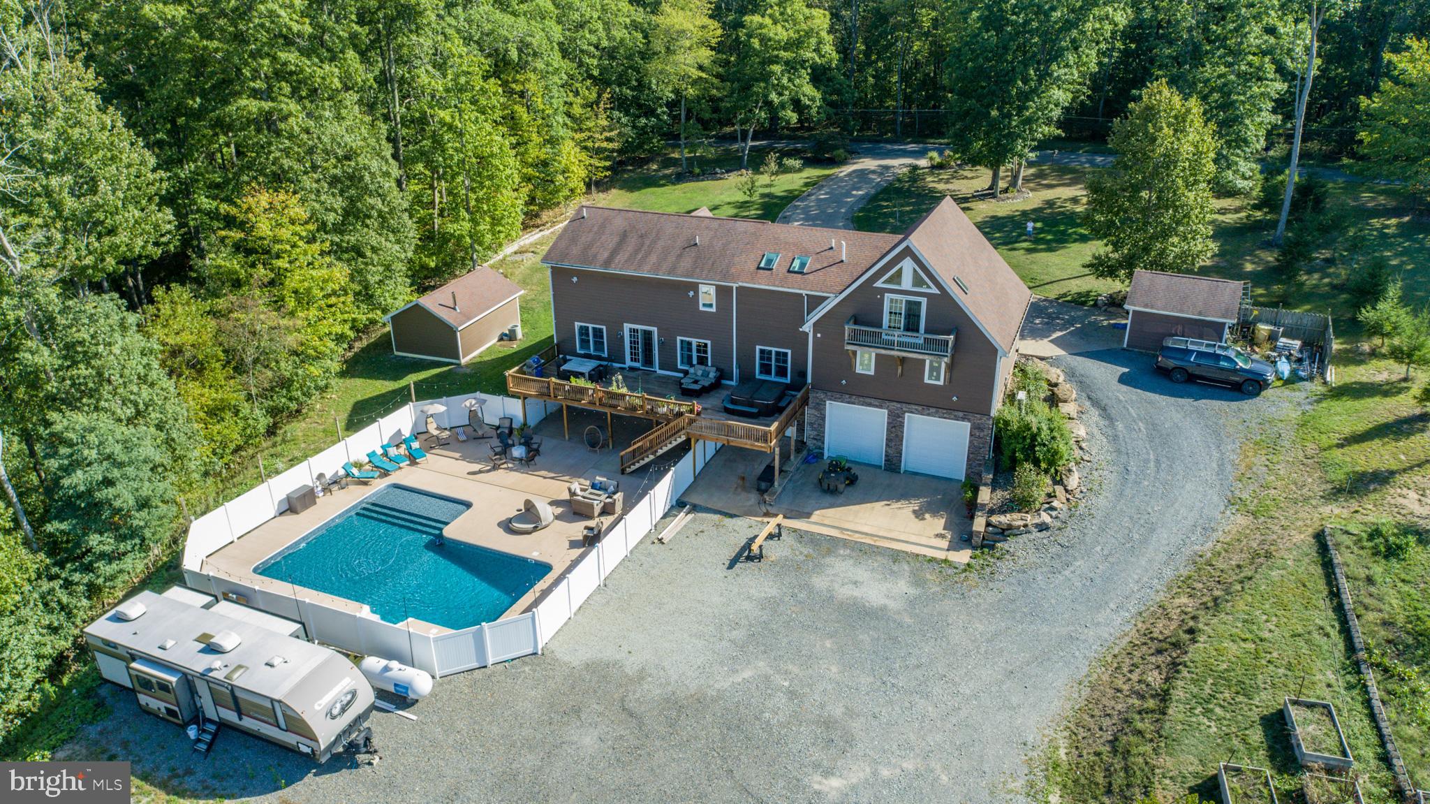 1909 Pysell Crosscut Road Oakland, MD 21550 - Photo 80 of 82 an aerial view of a house with swimming pool garden view and trees