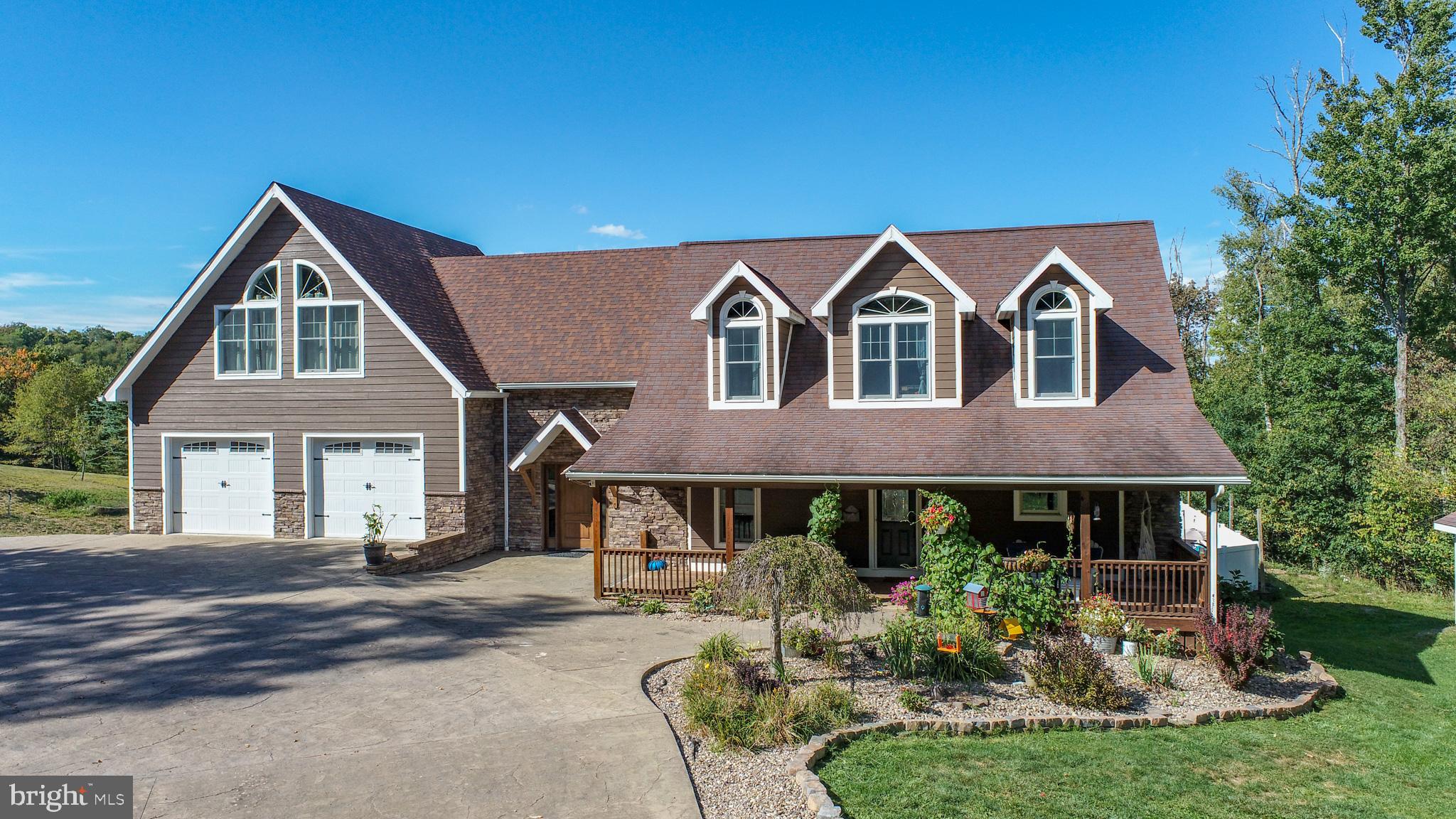 1909 Pysell Crosscut Road Oakland, MD 21550 - Photo 9 of 82 a front view of a house with a yard table and chairs