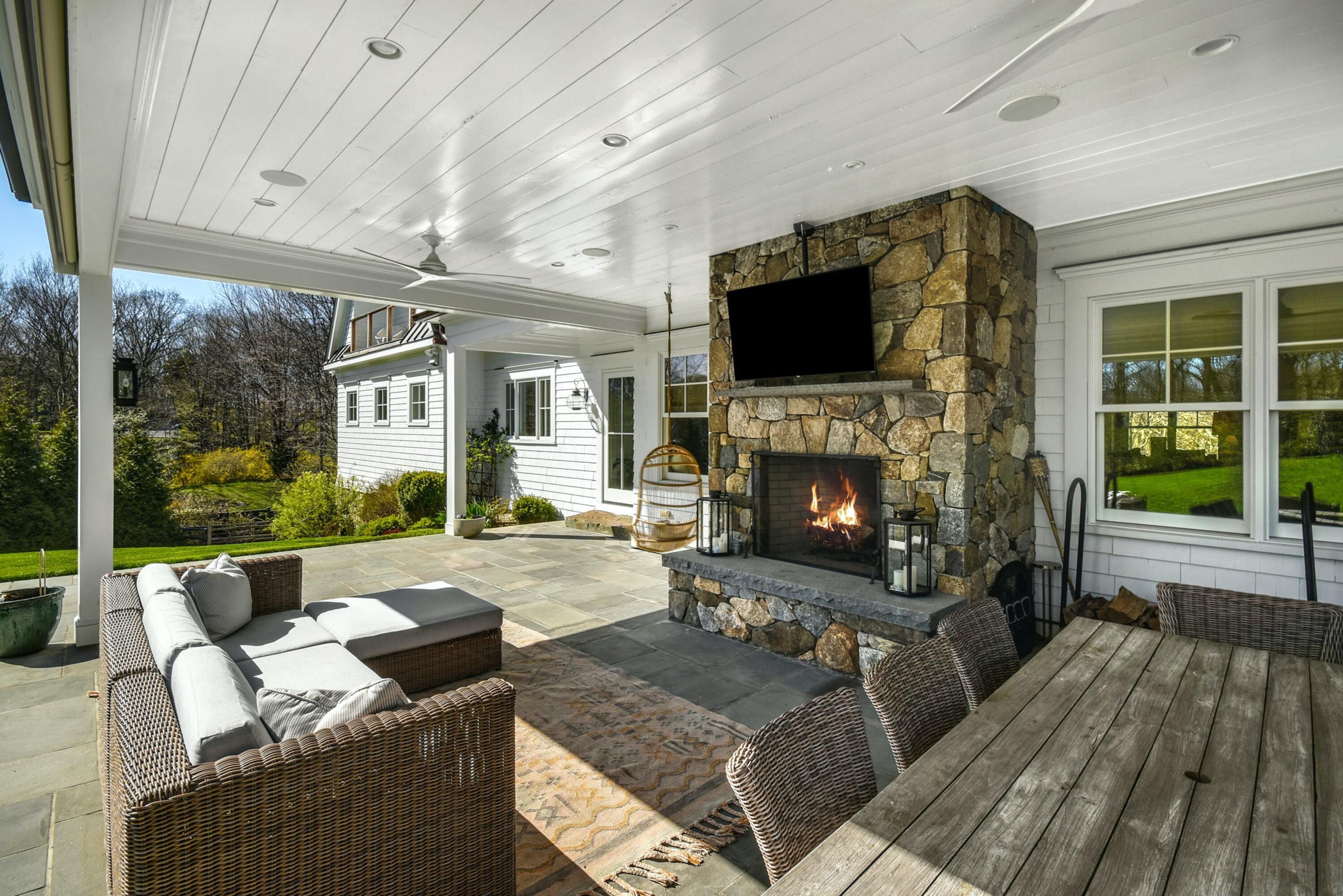 42 Delafield Island Road Darien, CT 06820 - Photo 34 of 39 a living room with furniture a flat screen tv and a fireplace