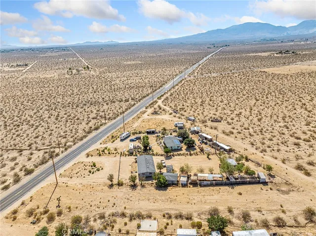a living room with furniture a couch and dresser next to a window
