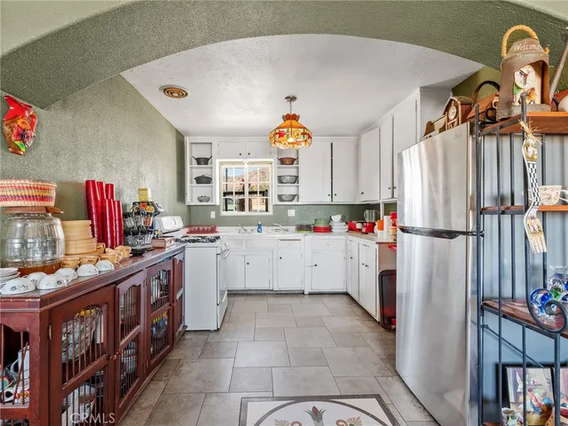 a view of a dining room with furniture chandelier and wooden floor