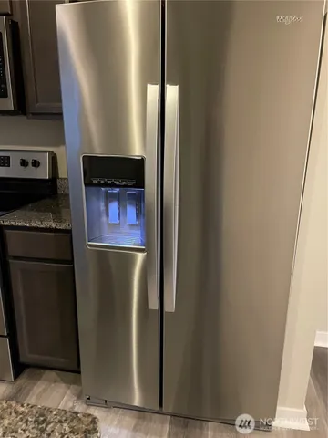 a kitchen with a refrigerator and a stove