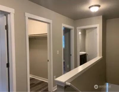 a view of a hallway with wooden floor