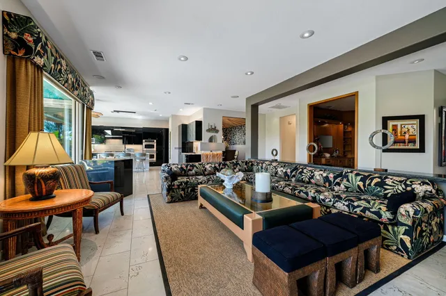 a kitchen with stainless steel appliances kitchen island granite countertop a stove and a sink