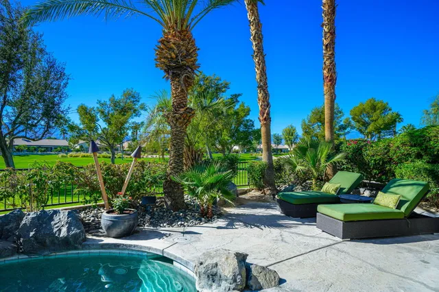 a view of a chair and table in the garden