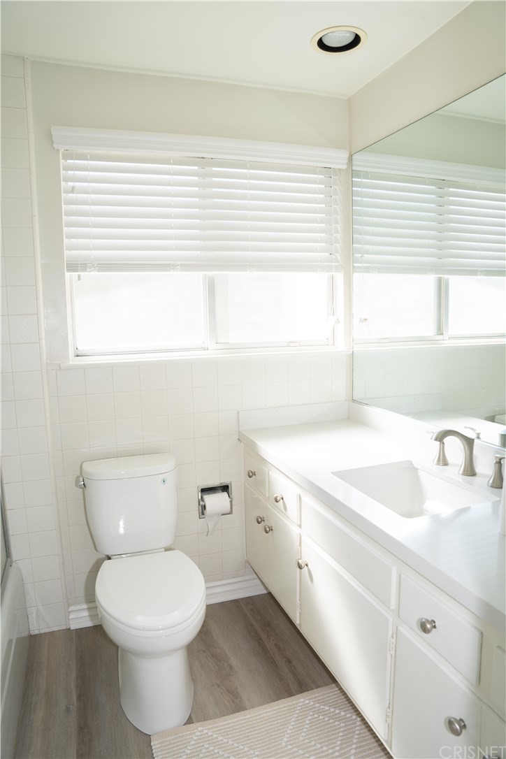 17236 Escalon Drive Encino, CA 91436 - Photo 11 of 12 a bathroom with a sink a toilet and a window