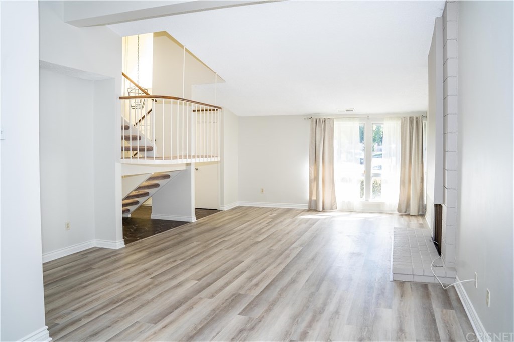 17236 Escalon Drive Encino, CA 91436 - Photo 2 of 12 an empty room with wooden floor cabinet and windows