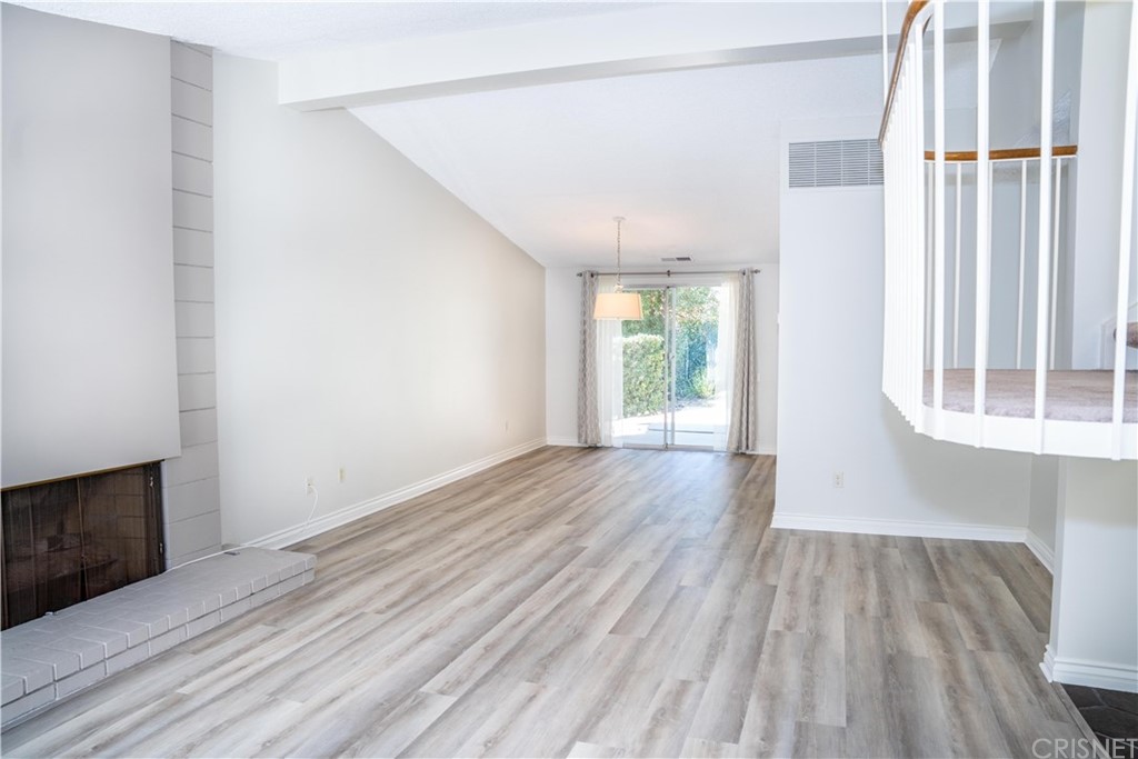 17236 Escalon Drive Encino, CA 91436 - Photo 3 of 12 an empty room with wooden floor and windows