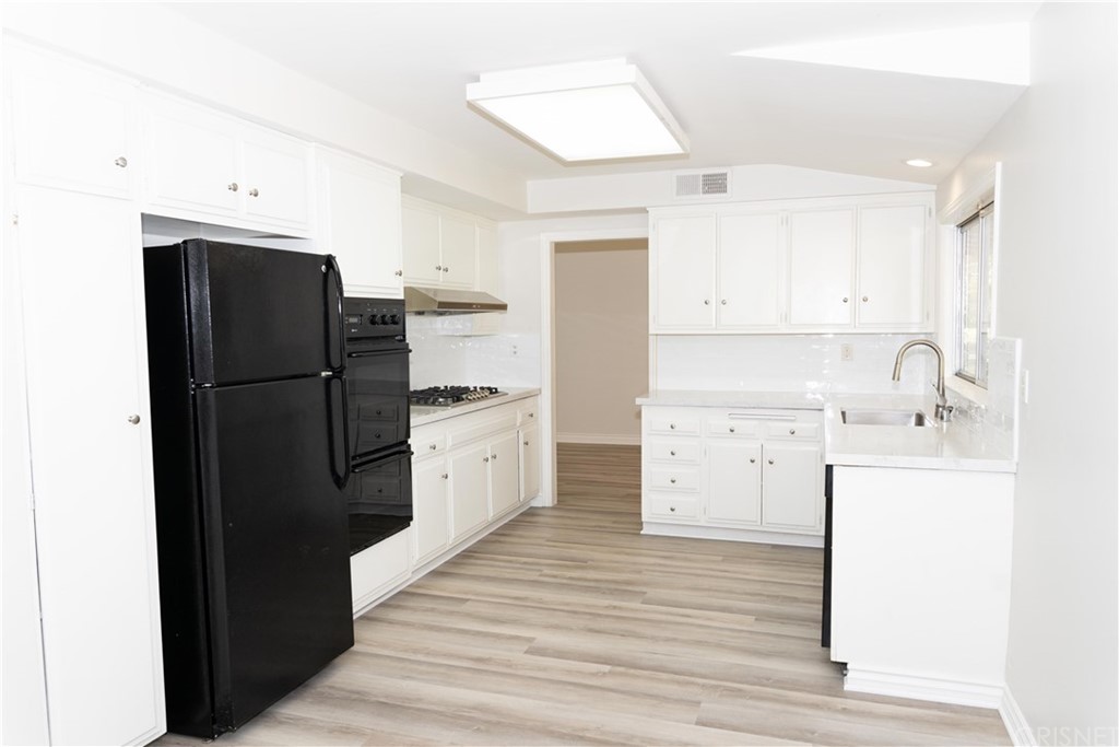 17236 Escalon Drive Encino, CA 91436 - Photo 4 of 12 a kitchen with a refrigerator and a stove