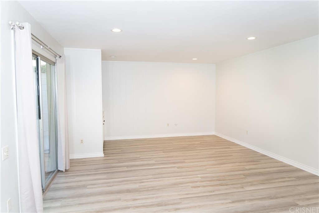 17236 Escalon Drive Encino, CA 91436 - Photo 5 of 12 a view of an empty room with wooden floor and a window