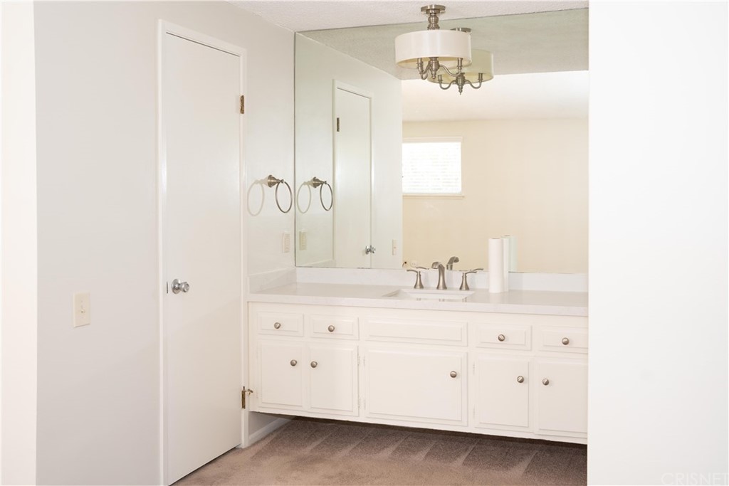 17236 Escalon Drive Encino, CA 91436 - Photo 10 of 12 a bathroom with a sink vanity and a mirror