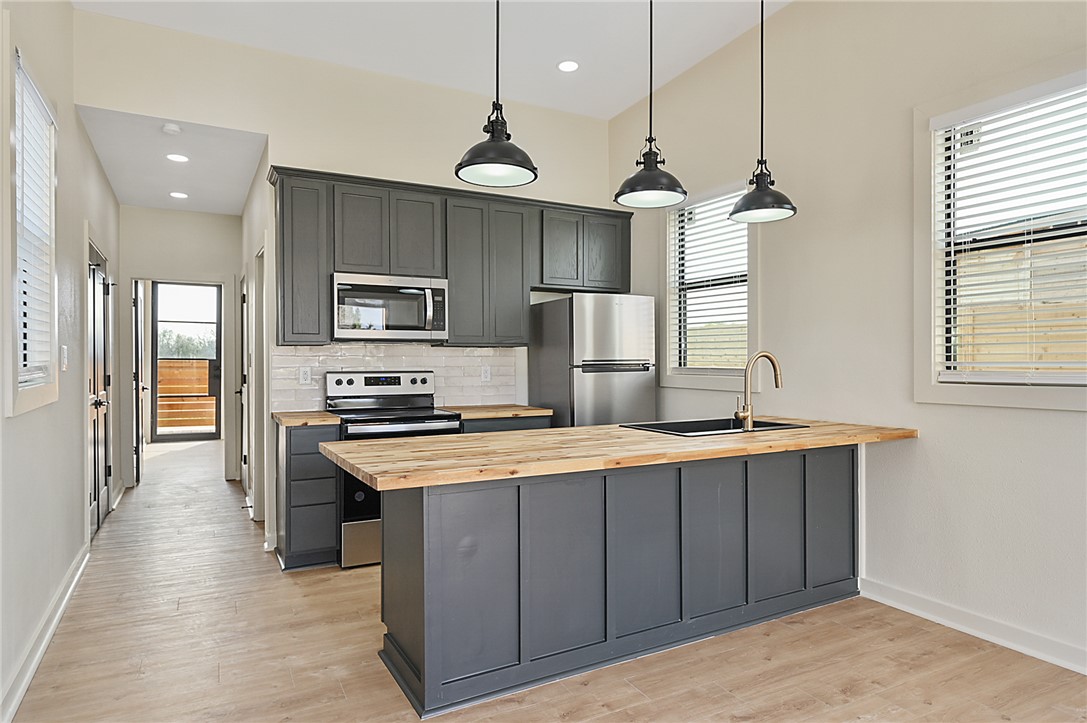 23900 Highway 6 Navasota, TX 77868 - Photo 5 of 22 a kitchen with kitchen island a sink stainless steel appliances and window