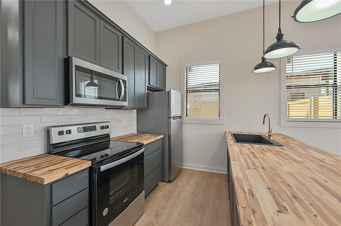 23900 Highway 6 Navasota, TX 77868 - Photo 6 of 22 a kitchen with stainless steel appliances granite countertop a stove and a microwave