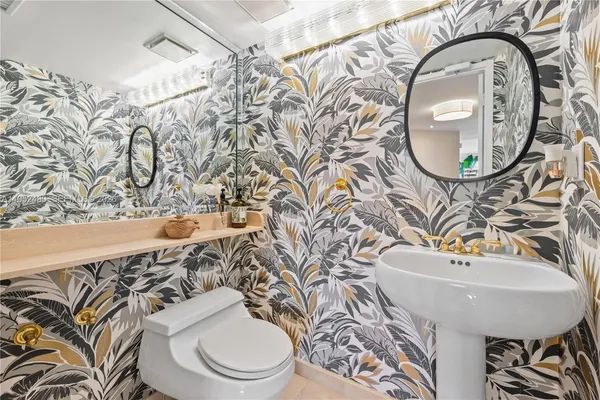 a bathroom with a toilet a sink and a mirror