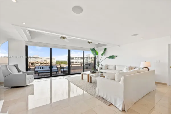 a living room with furniture and large windows
