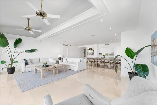 a living room with furniture potted plant and a chandelier