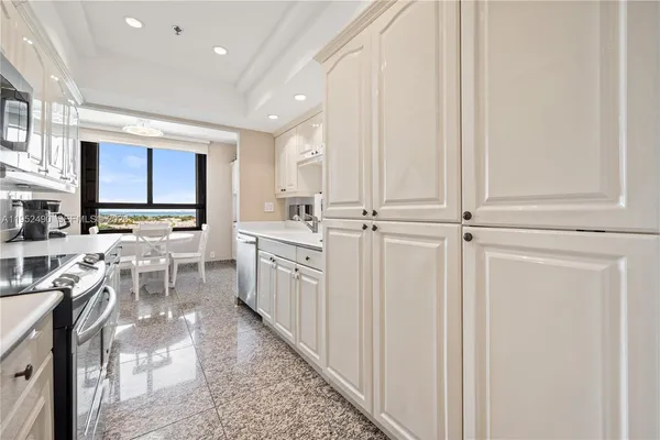 a view of a kitchen with furniture and wooden floor