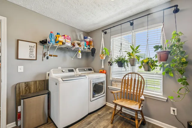 a view of patio with a table and chairs and potted plants